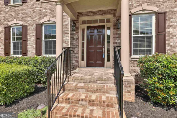 a view of a room with wooden floor and staircase