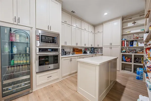 a kitchen with stainless steel appliances a stove a sink and a refrigerator