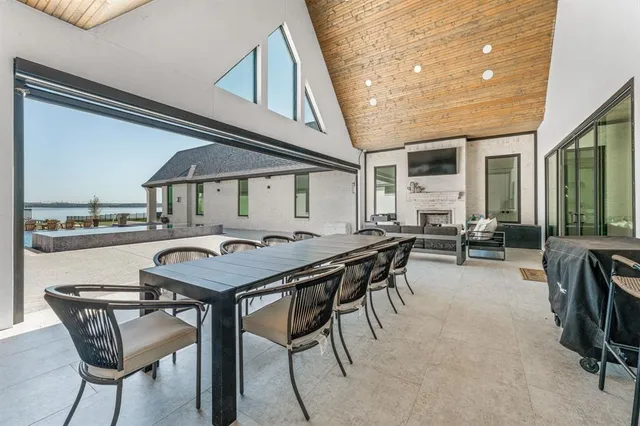 a roof deck with table and chairs