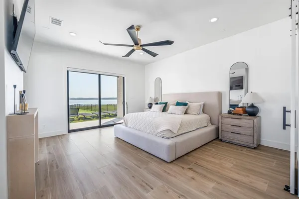 a spacious bedroom with a bed and large windows