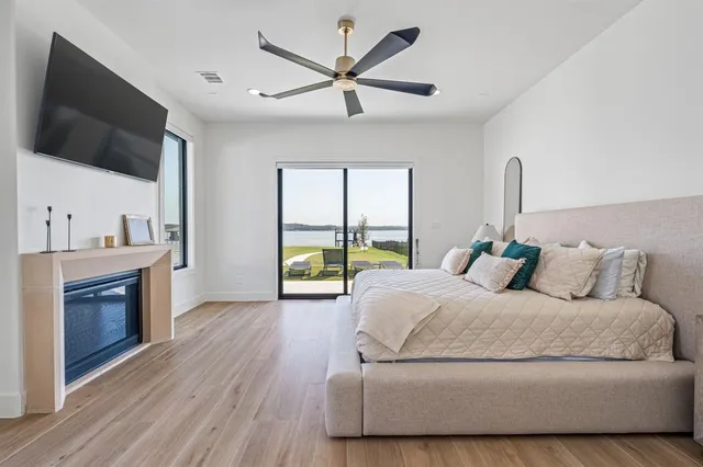 a living room with a bed furniture and a flat screen tv