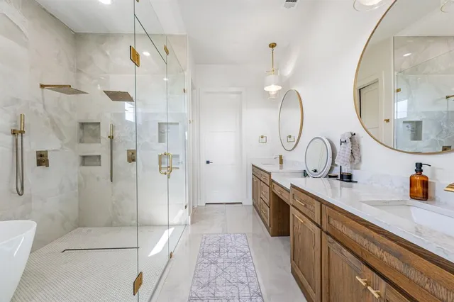 a spacious bathroom with double sink and shower