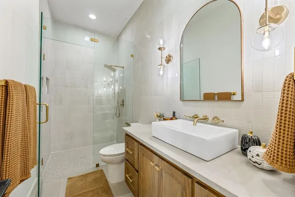 a bathroom with a sink toilet and shower