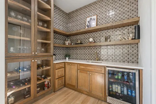 a view of a kitchen with fridge and rack