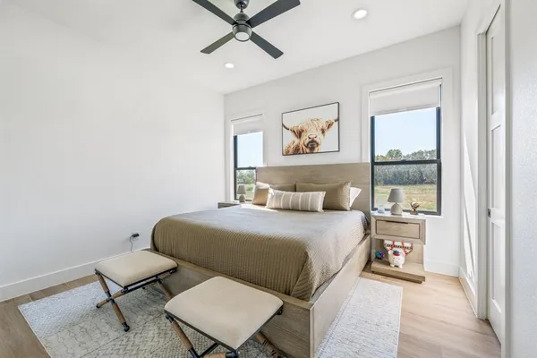 a bedroom with a bed and wooden floor