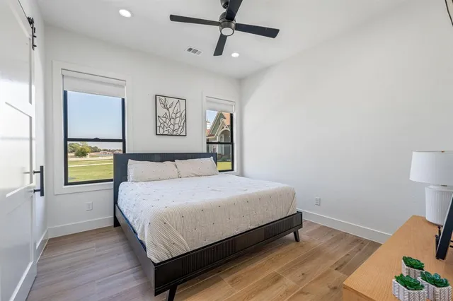 a bedroom with a bed dresser and a window