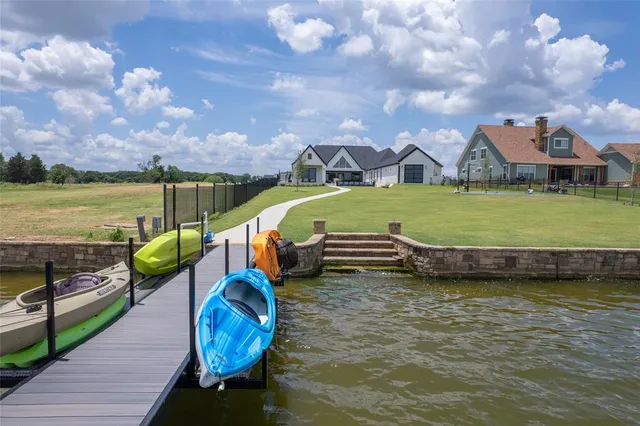 a view of a lake with couches chairs and city view