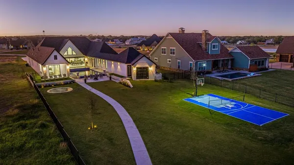 an aerial view of residential houses with yard and mountain view