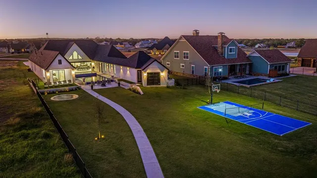 an aerial view of residential houses with yard and mountain view