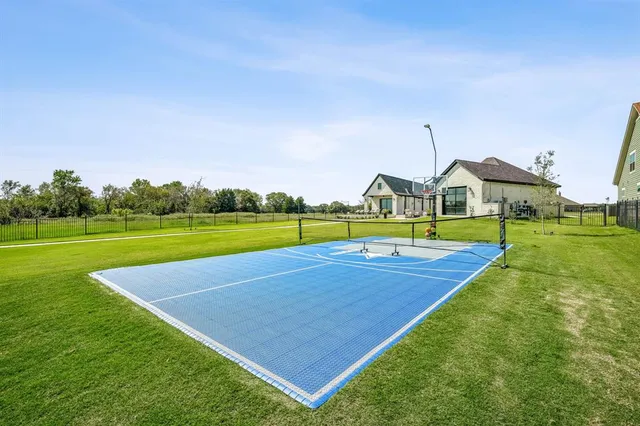 a view of yard with swimming pool and green space