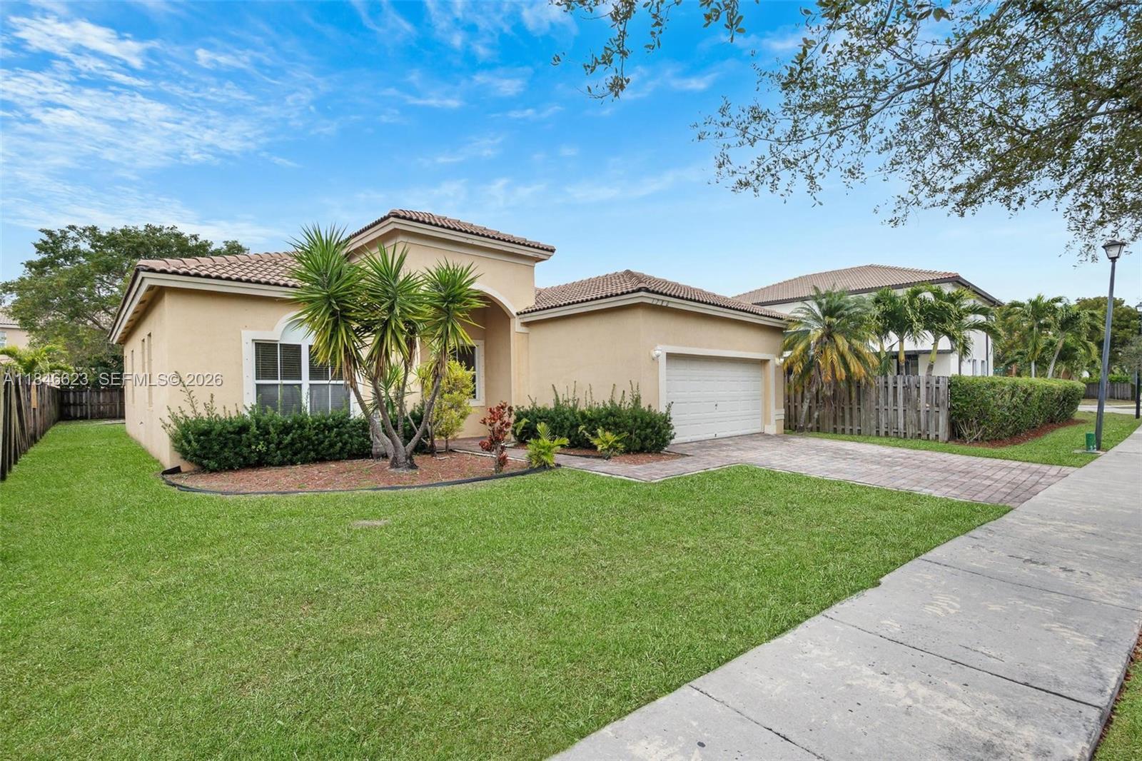 1780 Southeast 19th Terrace Homestead, FL 33035 - Photo 2 of 70 a front view of a house with garden