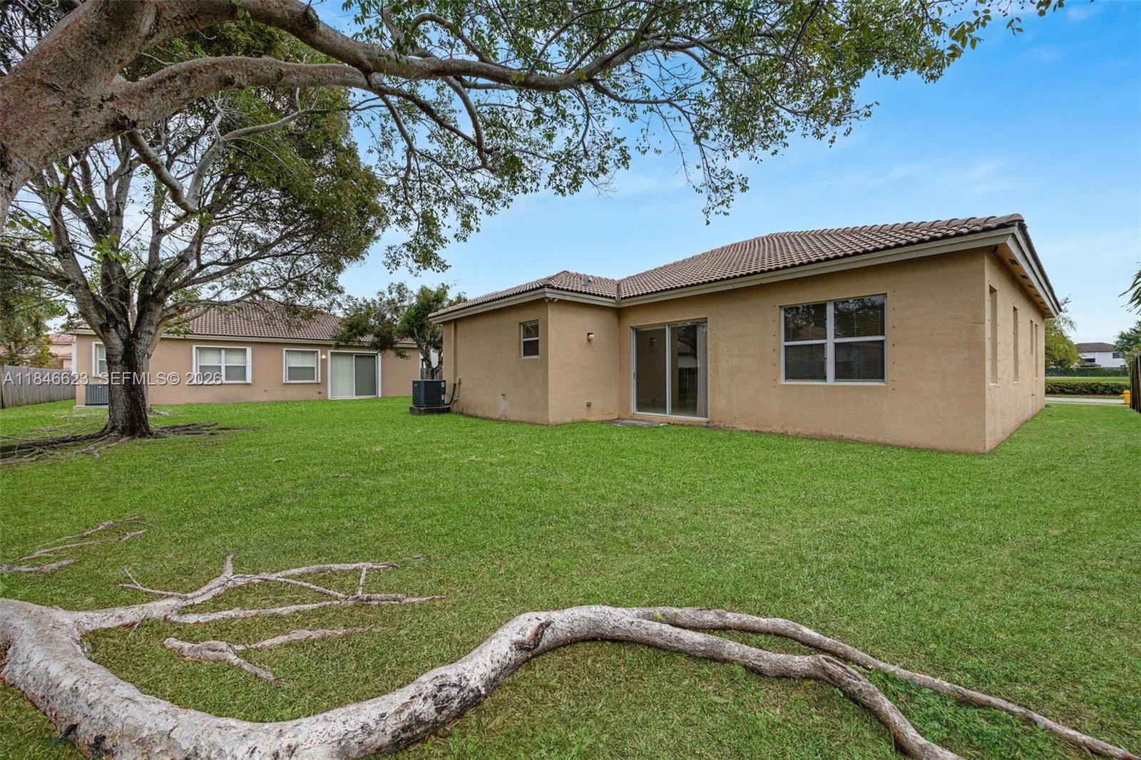 1780 Southeast 19th Terrace Homestead, FL 33035 - Photo 47 of 70 a backyard of a house with a garden and plants