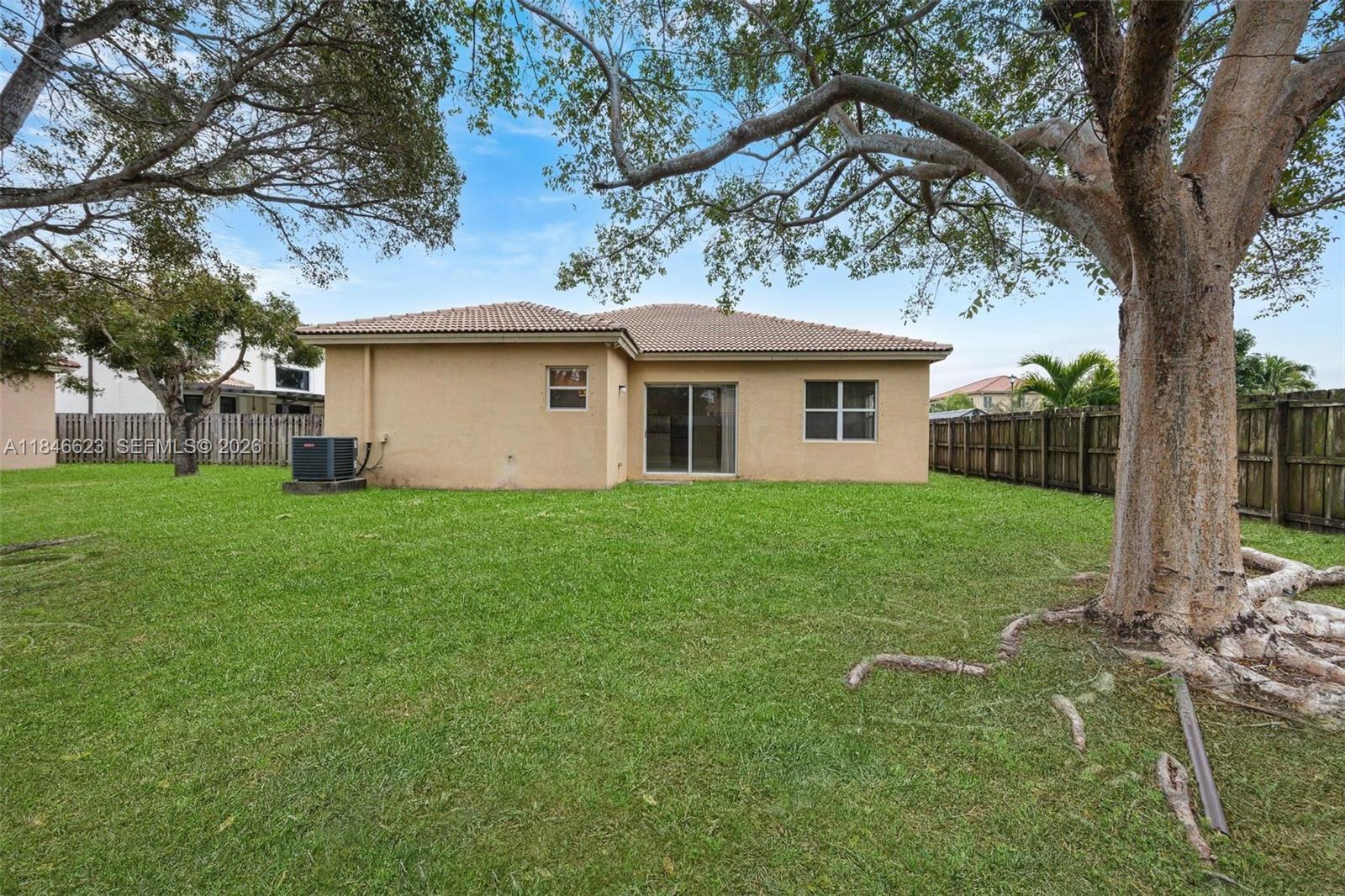 1780 Southeast 19th Terrace Homestead, FL 33035 - Photo 48 of 70 a house that has a tree in front of it