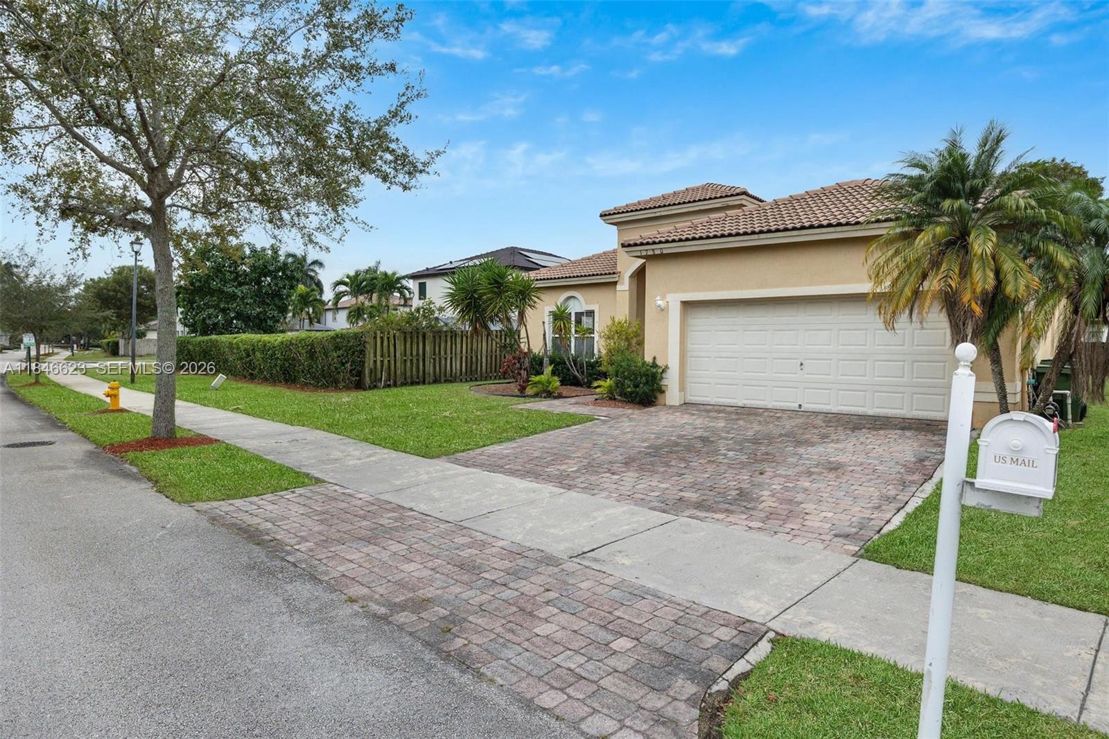 1780 Southeast 19th Terrace Homestead, FL 33035 - Photo 5 of 70 a view of a white house with a yard and potted plants