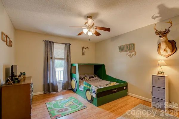 a bed room with a bed and a chandelier