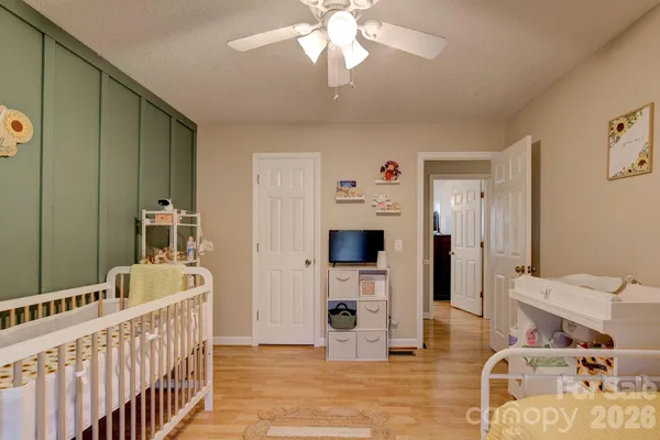 a bedroom with furniture and wooden floor