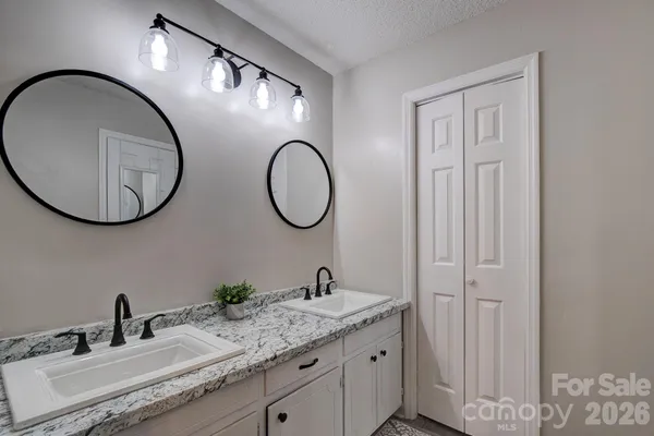 a bathroom with a double vanity sink and a mirror