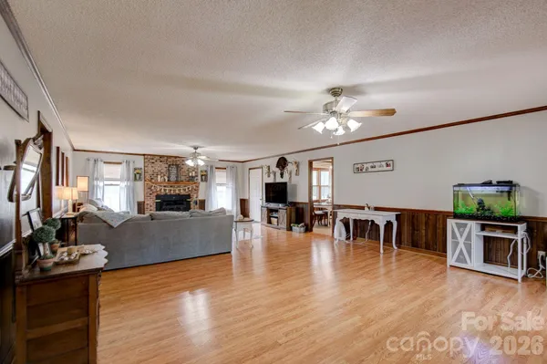 a view of a dining room with furniture a chandelier and wooden floor