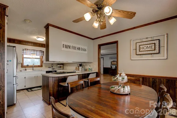 a view of a dining room with furniture a chandelier and wooden floor