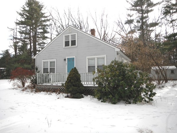 87 Lowell Road Pepperell, MA 01463 - Photo 1 of 15 a front view of a house with a yard covered in snow