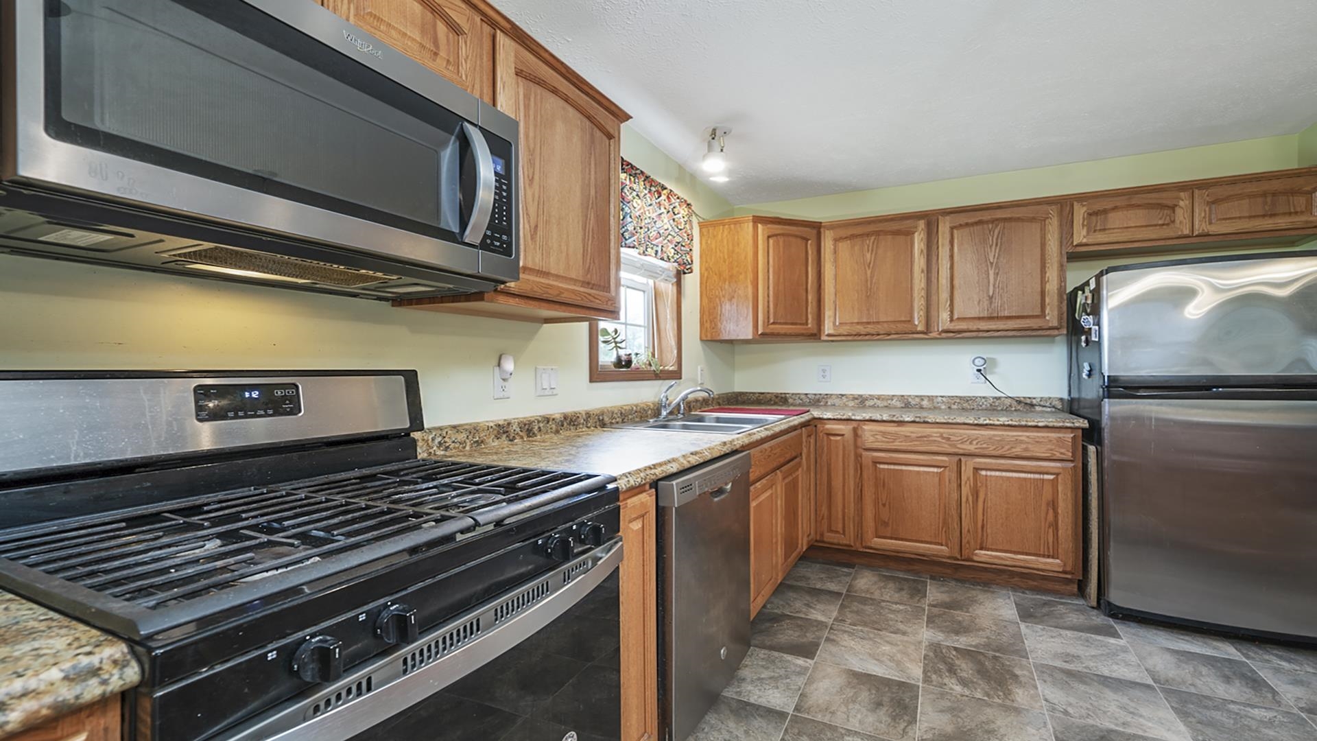 820 Brooklyn Road West Brooklyn, IL 61378 - Photo 21 of 41 a kitchen with stainless steel appliances granite countertop a stove and a sink