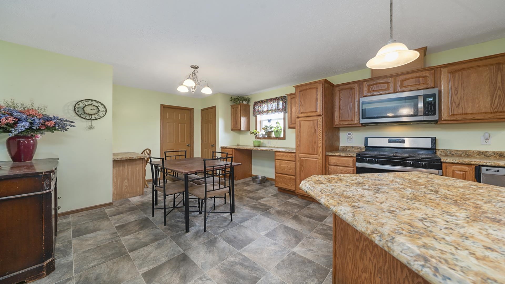 820 Brooklyn Road West Brooklyn, IL 61378 - Photo 23 of 41 a kitchen with microwave a stove and cabinets