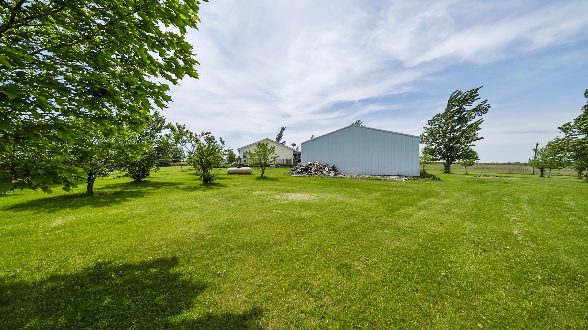 820 Brooklyn Road West Brooklyn, IL 61378 - Photo 6 of 41 a backyard of a house with lots of green space and garden