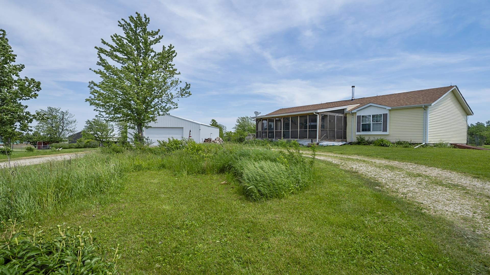 820 Brooklyn Road West Brooklyn, IL 61378 - Photo 10 of 41 a view of a house with a big yard and large trees