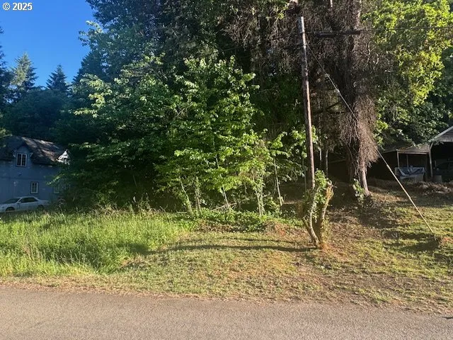 a backyard of a house with a yard and outdoor seating