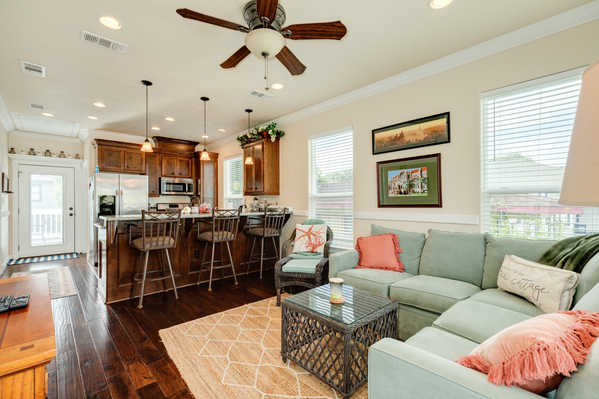 4317 Avenue R Galveston, TX 77550 - Photo 16 of 27 a living room with furniture kitchen view and a wooden floor