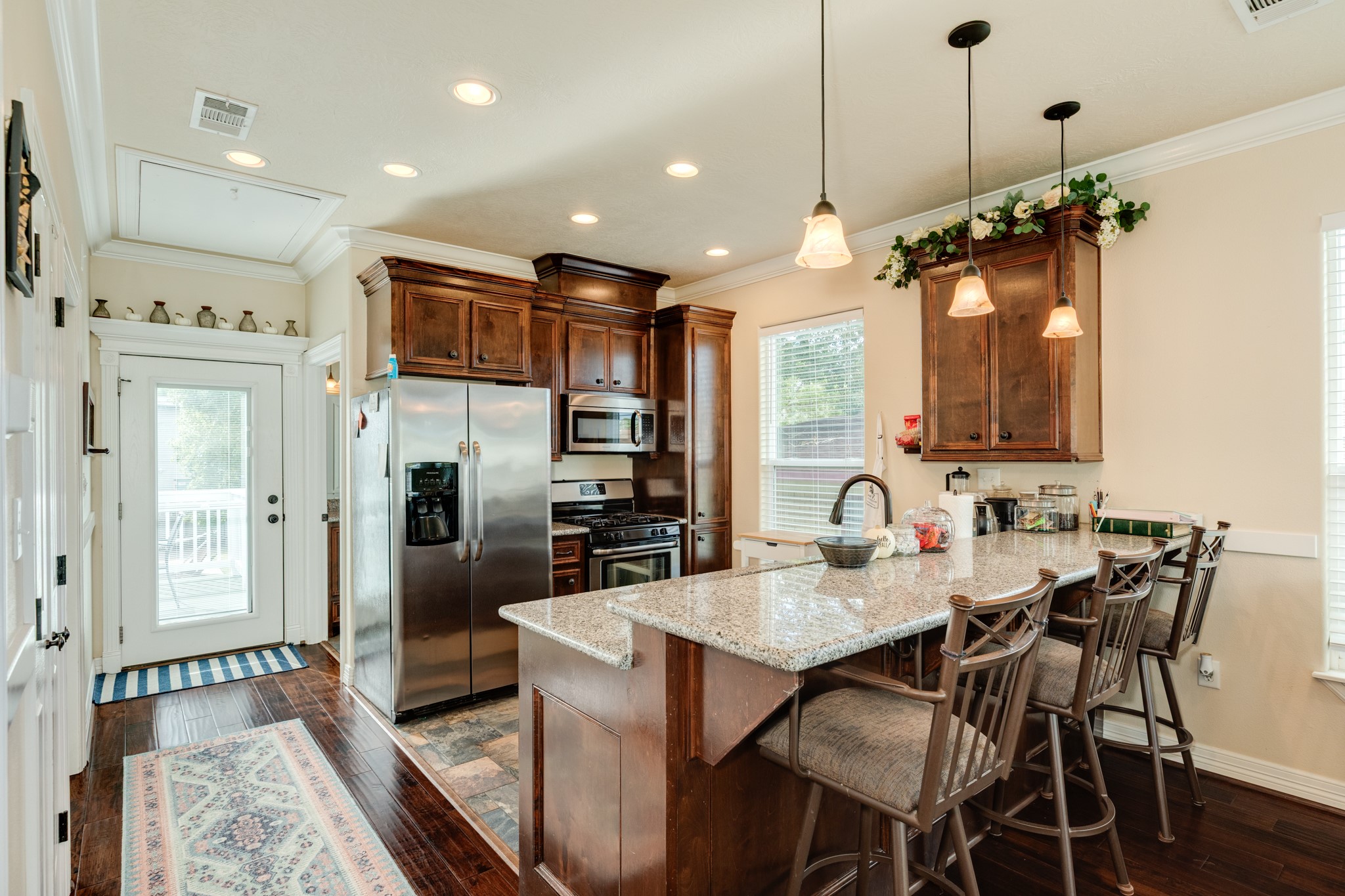 4317 Avenue R Galveston, TX 77550 - Photo 18 of 27 a kitchen with refrigerator a sink and chairs