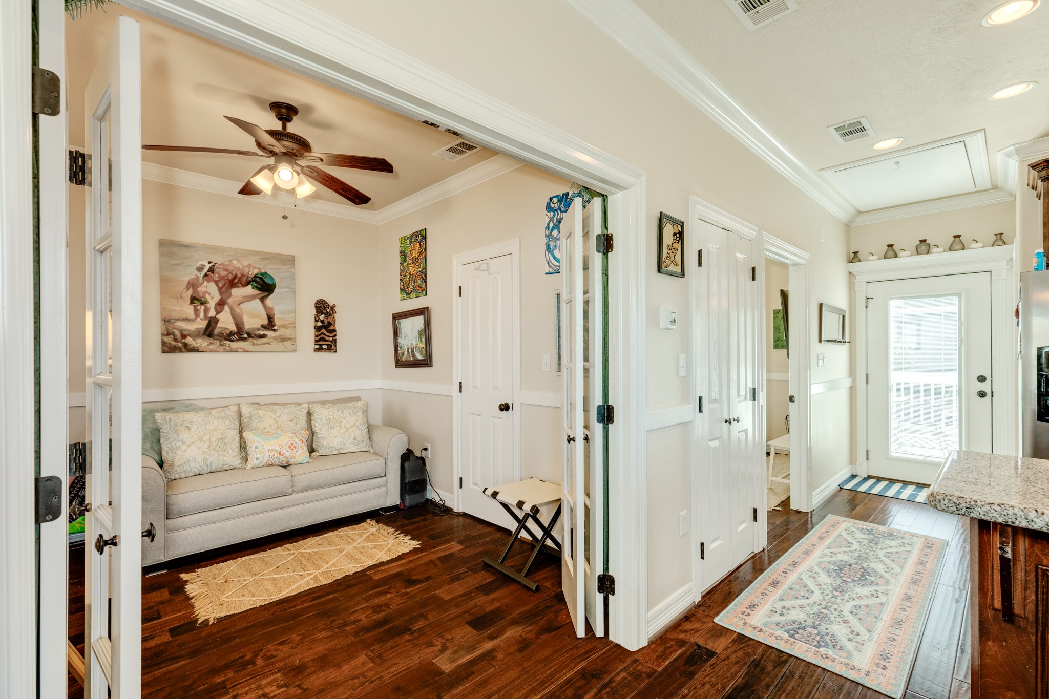 4317 Avenue R Galveston, TX 77550 - Photo 22 of 27 a view of an entryway with wooden floor and a ceiling fan
