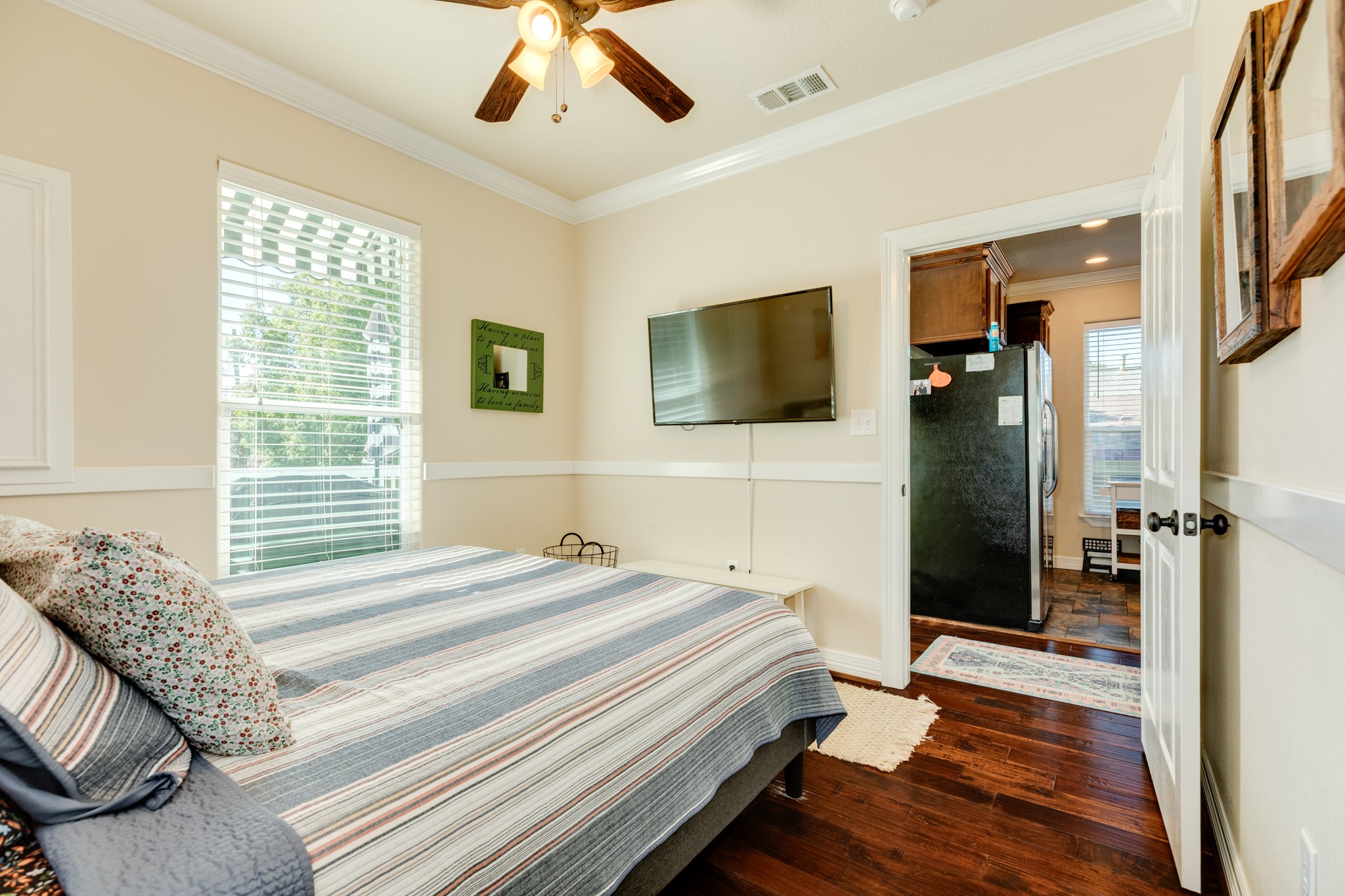 4317 Avenue R Galveston, TX 77550 - Photo 26 of 27 a bedroom with a bed and a flat screen tv