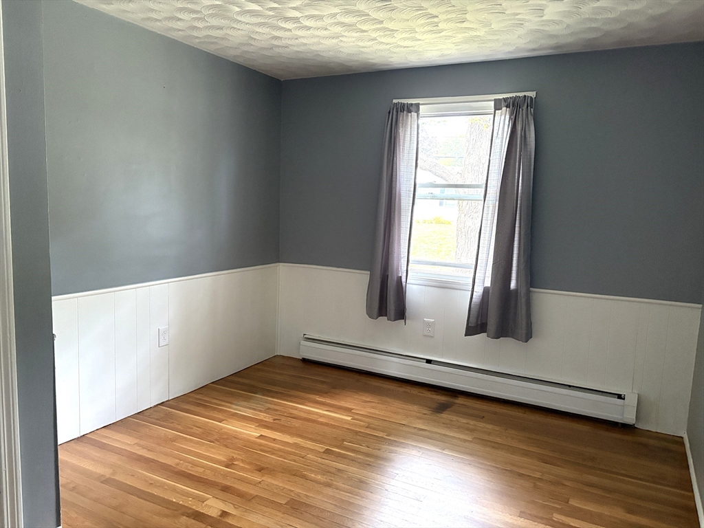 21 David Street Enfield, CT 06082 - Photo 11 of 21 a view of empty room with wooden floor and fan