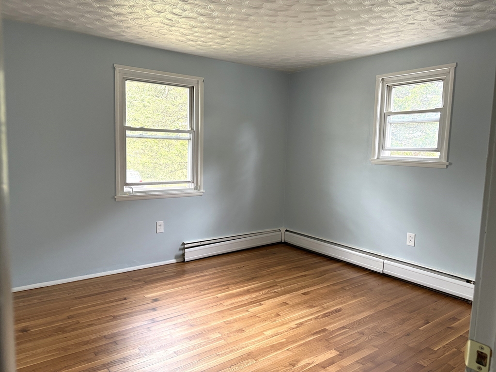 21 David Street Enfield, CT 06082 - Photo 12 of 21 an empty room with wooden floor and windows