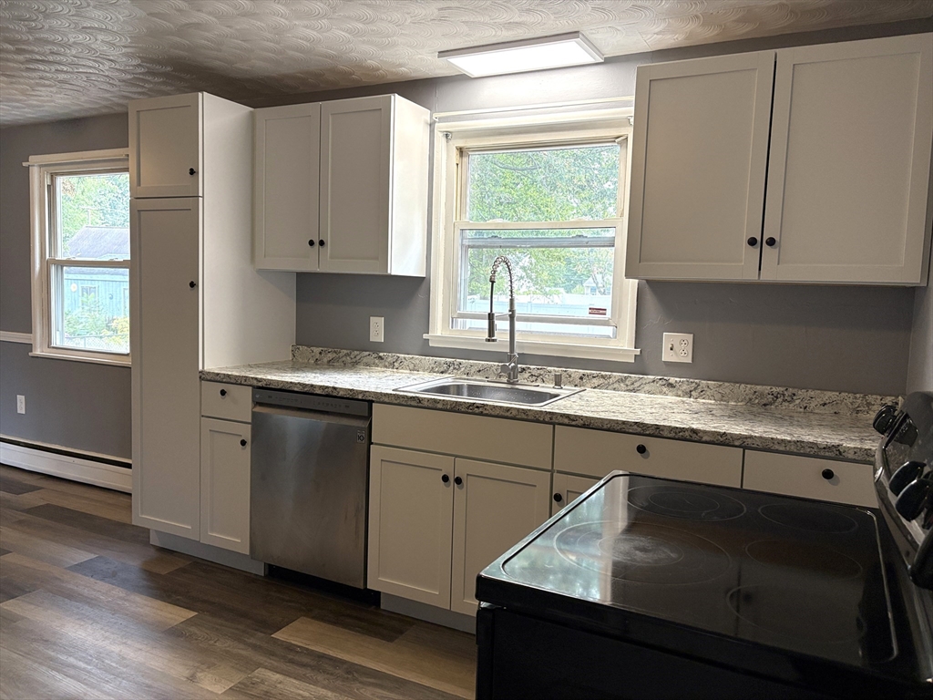 21 David Street Enfield, CT 06082 - Photo 2 of 21 a kitchen with a sink stove and cabinets