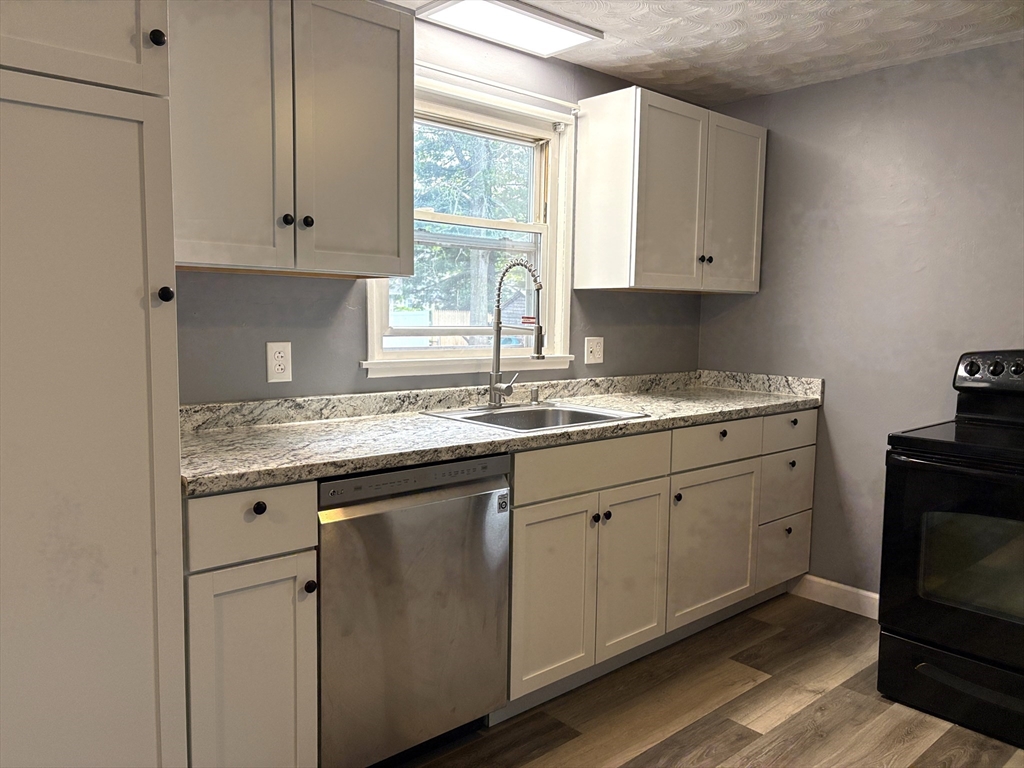 21 David Street Enfield, CT 06082 - Photo 6 of 21 a kitchen with granite countertop white cabinets and white appliances