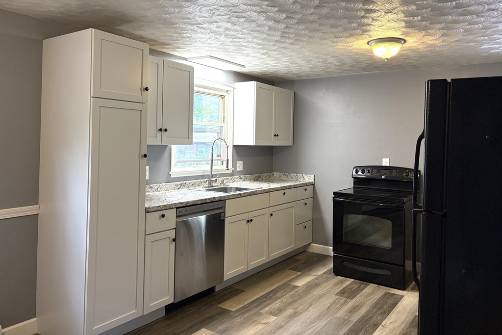 21 David Street Enfield, CT 06082 - Photo 7 of 21 a kitchen with a sink stove and refrigerator