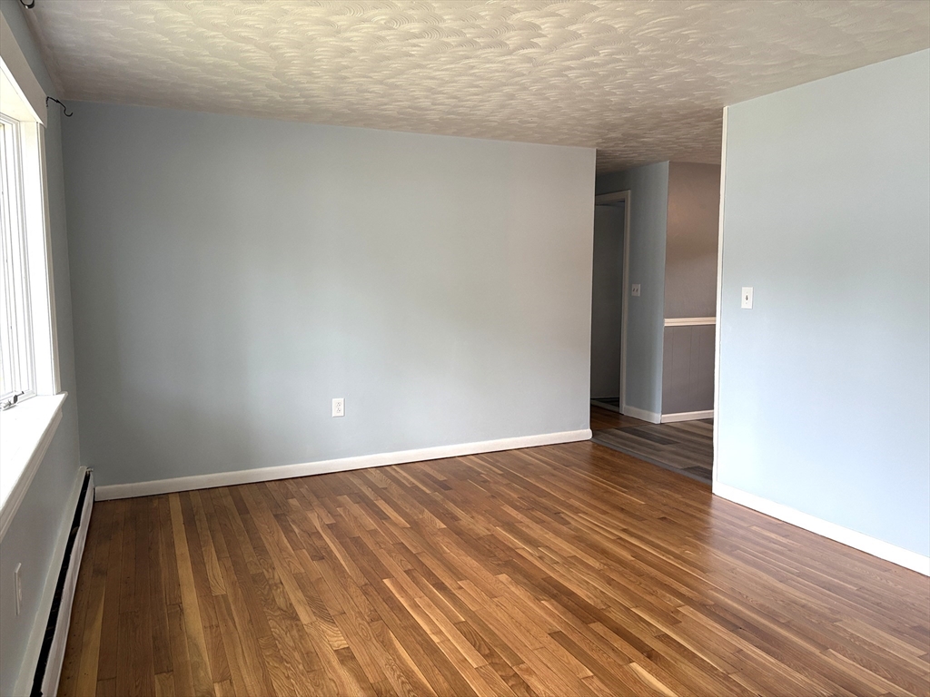 21 David Street Enfield, CT 06082 - Photo 9 of 21 a view of an empty room with wooden floor and a window