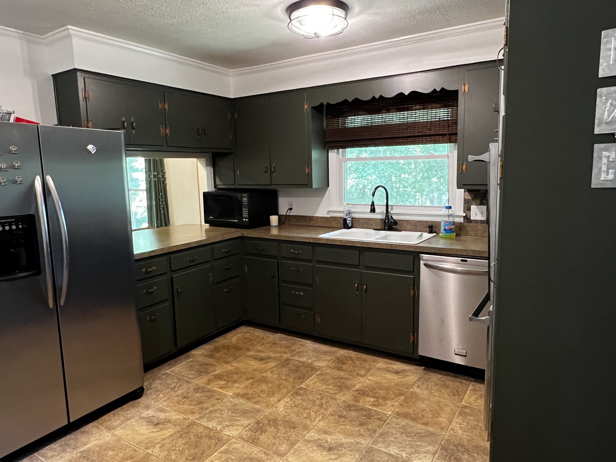 304 South Hummingbird Lane Dickson, TN 37055 - Photo 21 of 37 a kitchen with a sink stove and refrigerator