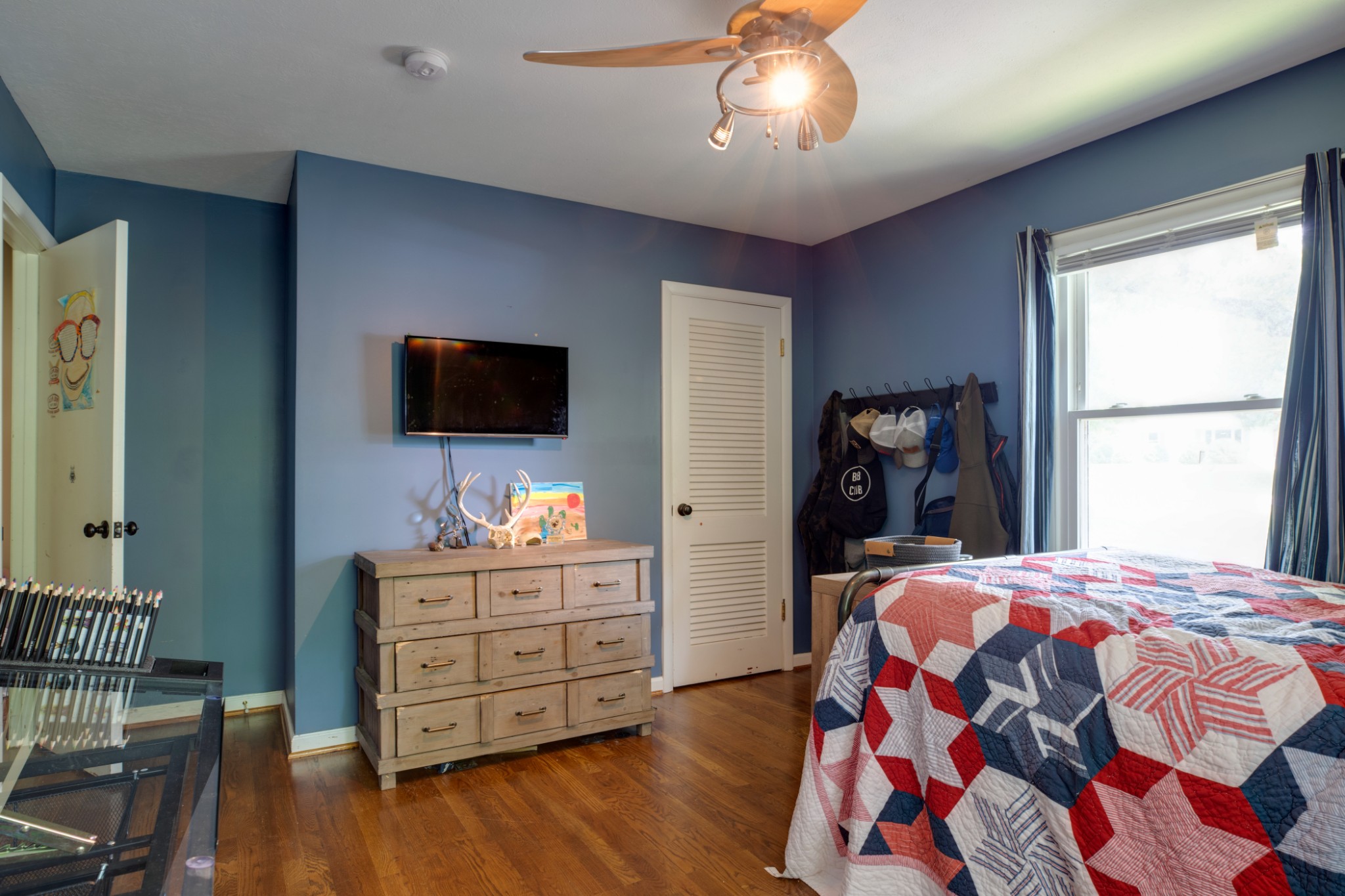 304 South Hummingbird Lane Dickson, TN 37055 - Photo 25 of 37 a bedroom with a bed and a flat tv screen on dresser