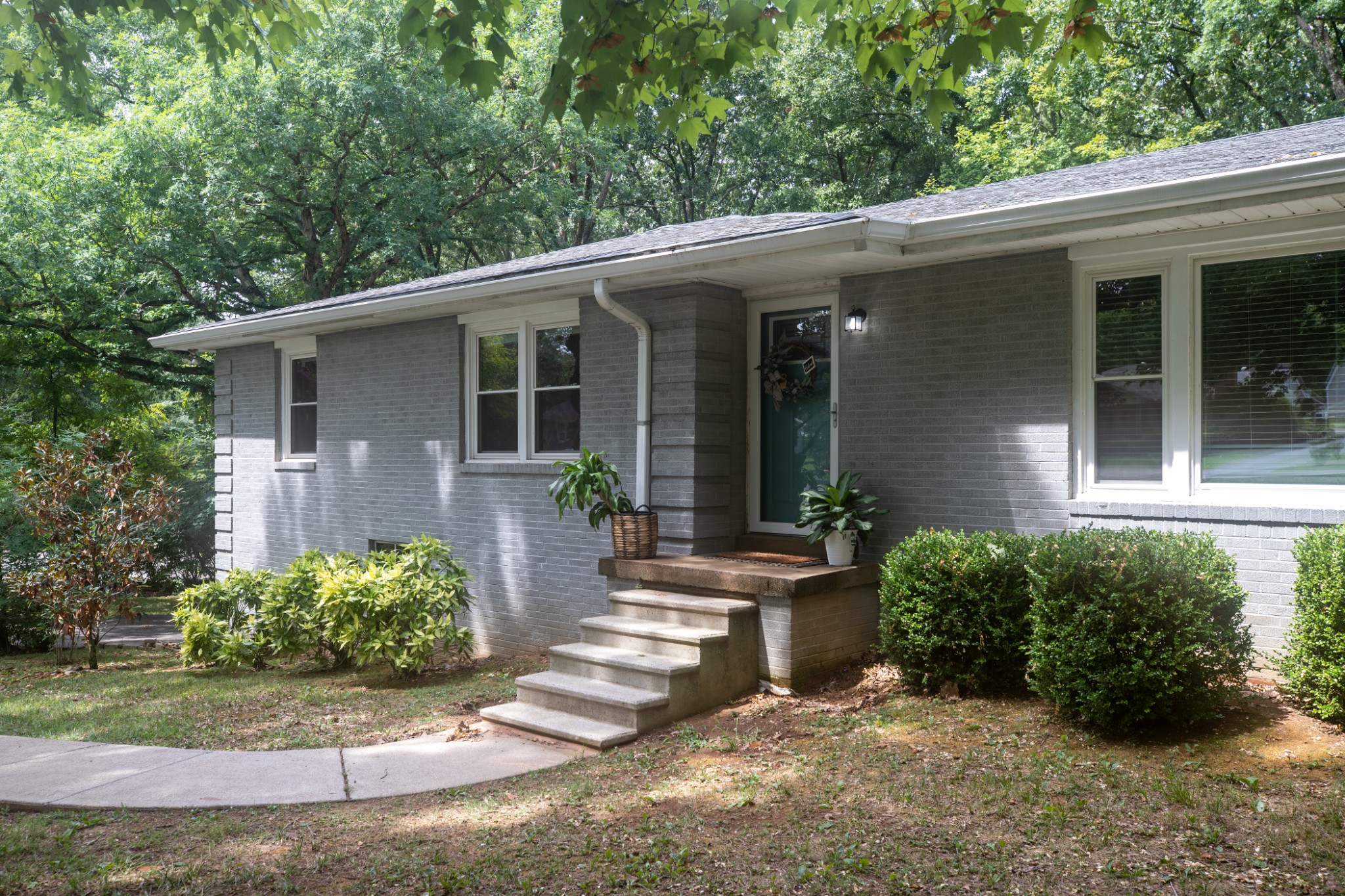 304 South Hummingbird Lane Dickson, TN 37055 - Photo 3 of 37 a view of a house with potted plants and a table and chairs