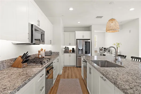 a kitchen with center island and stainless steel appliances