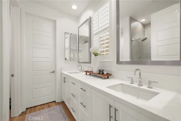 a bathroom with a shower sink and mirror