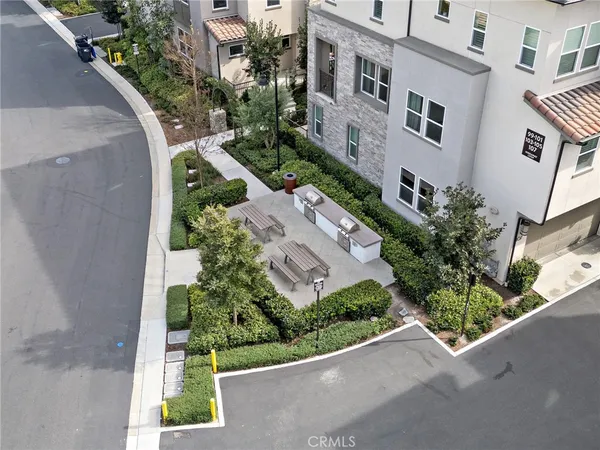 an aerial view of a house with a garden and trees