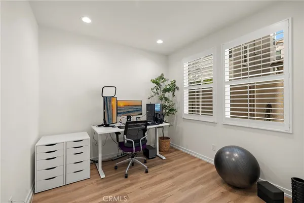 a view of a workspace with furniture and a window