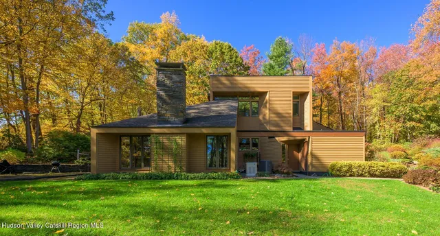 a view of a house with a yard and sitting area