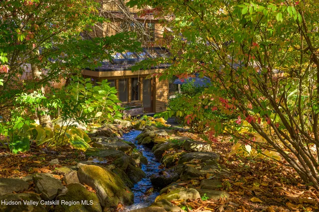 a living room with furniture and a book shelf