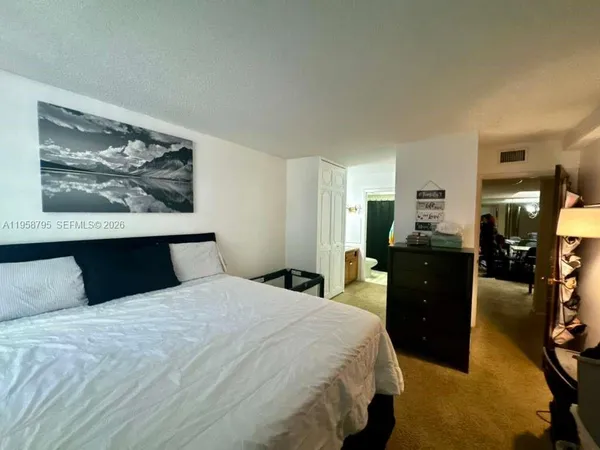 a bedroom with a bed and dresser