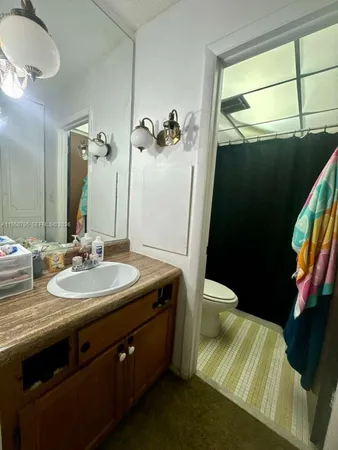 a white toilet sitting next to a shower curtain
